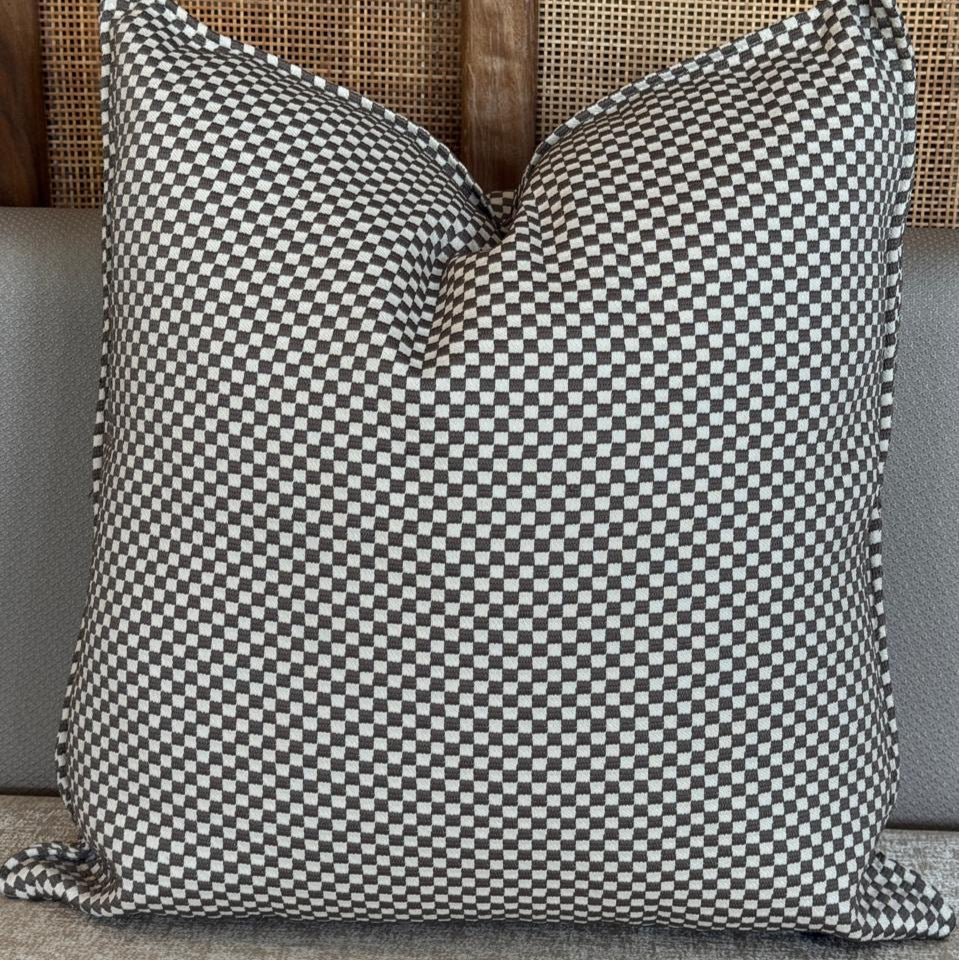 Coussin décoratif taupe avec motif organique en relief, au style moderne et naturel.