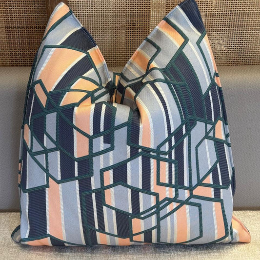 Coussin décoratif géométrique moderne bleu et vert.