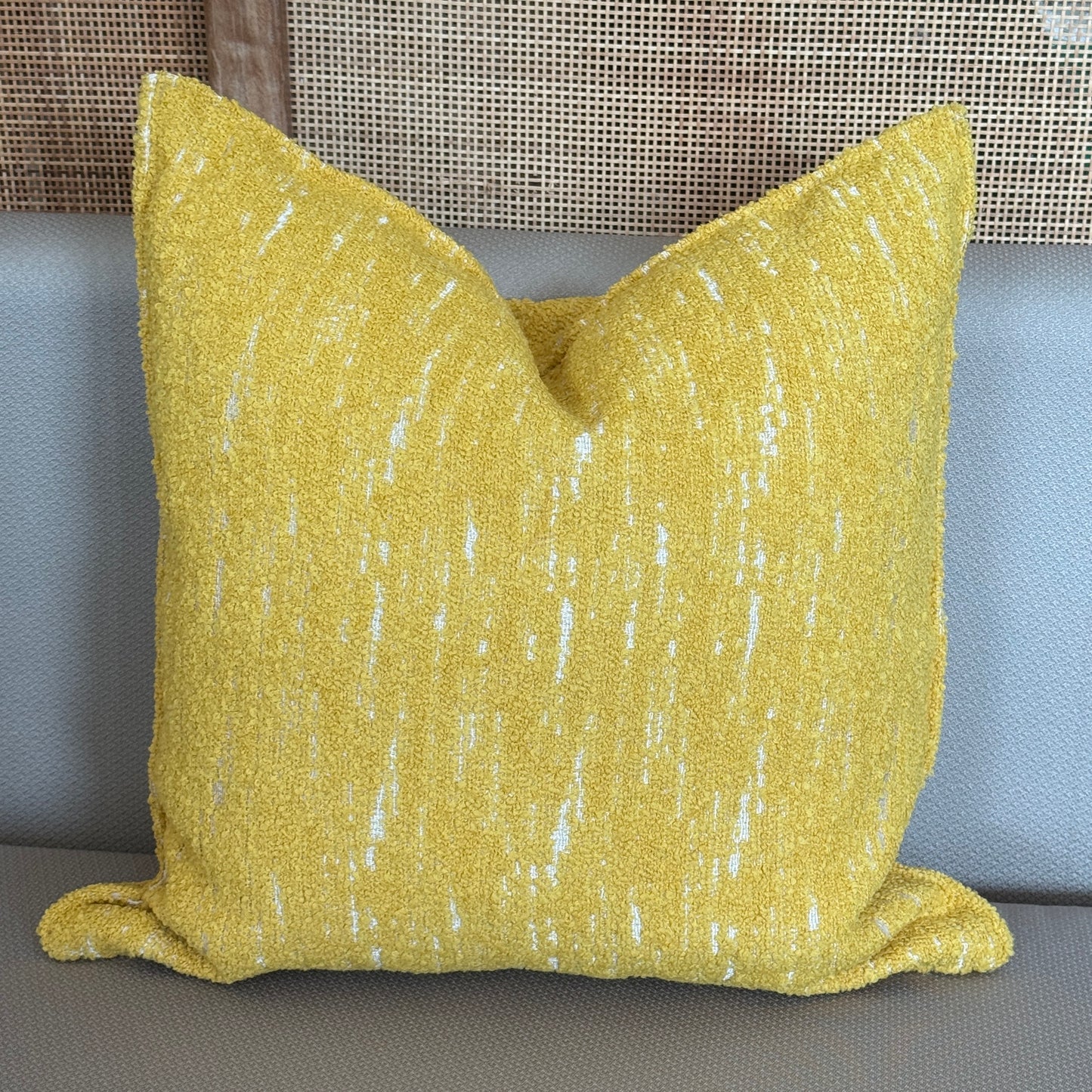  Coussin décoratif carré en tissu texturé jaune avec légères touches blanches, idéal pour canapé ou salon moderne.