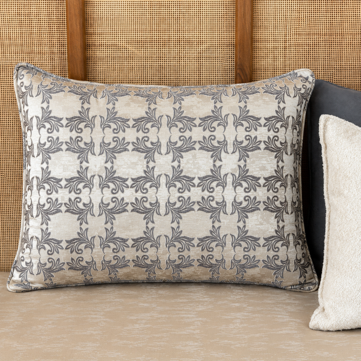 Tissu Arabesques Élégantes gris et beige à motif classique en relief, présenté dans une composition de salon raffinée, tissé au Maroc par Biyadi Collection.