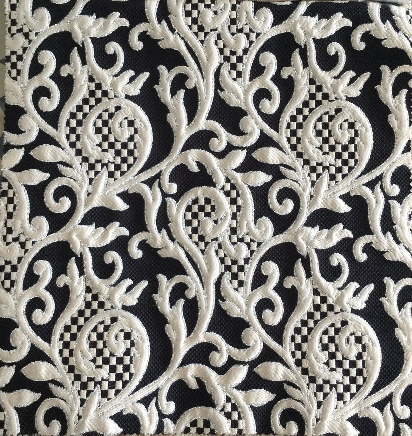 Tissu d’ameublement damassé noir et écru avec arabesques florales tissées en relief. Un tissu élégant et lumineux, idéal pour salons marocains, coussins, fauteuils et décoration intérieure.