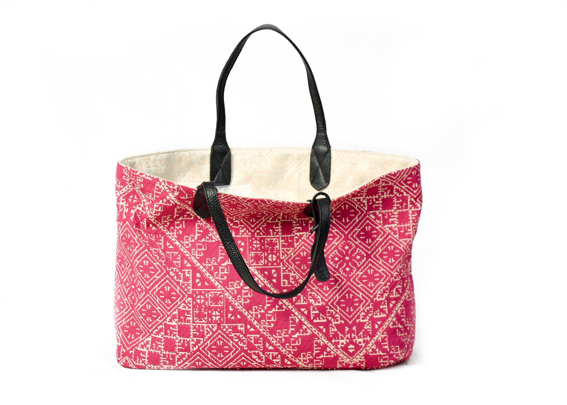 Sac cabas réversible fushia et verteau  en tissu marocain tissé avec anses en cuir noir et motif géométrique inspiré du patrimoine marocain.